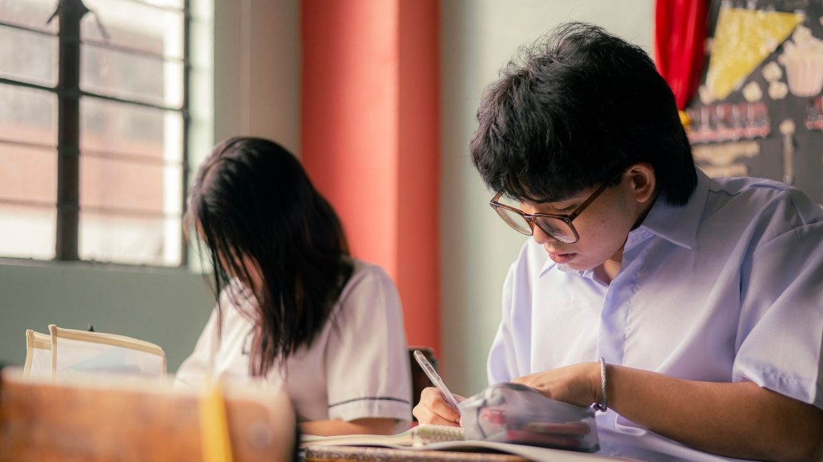 教室で真剣に勉強する学生